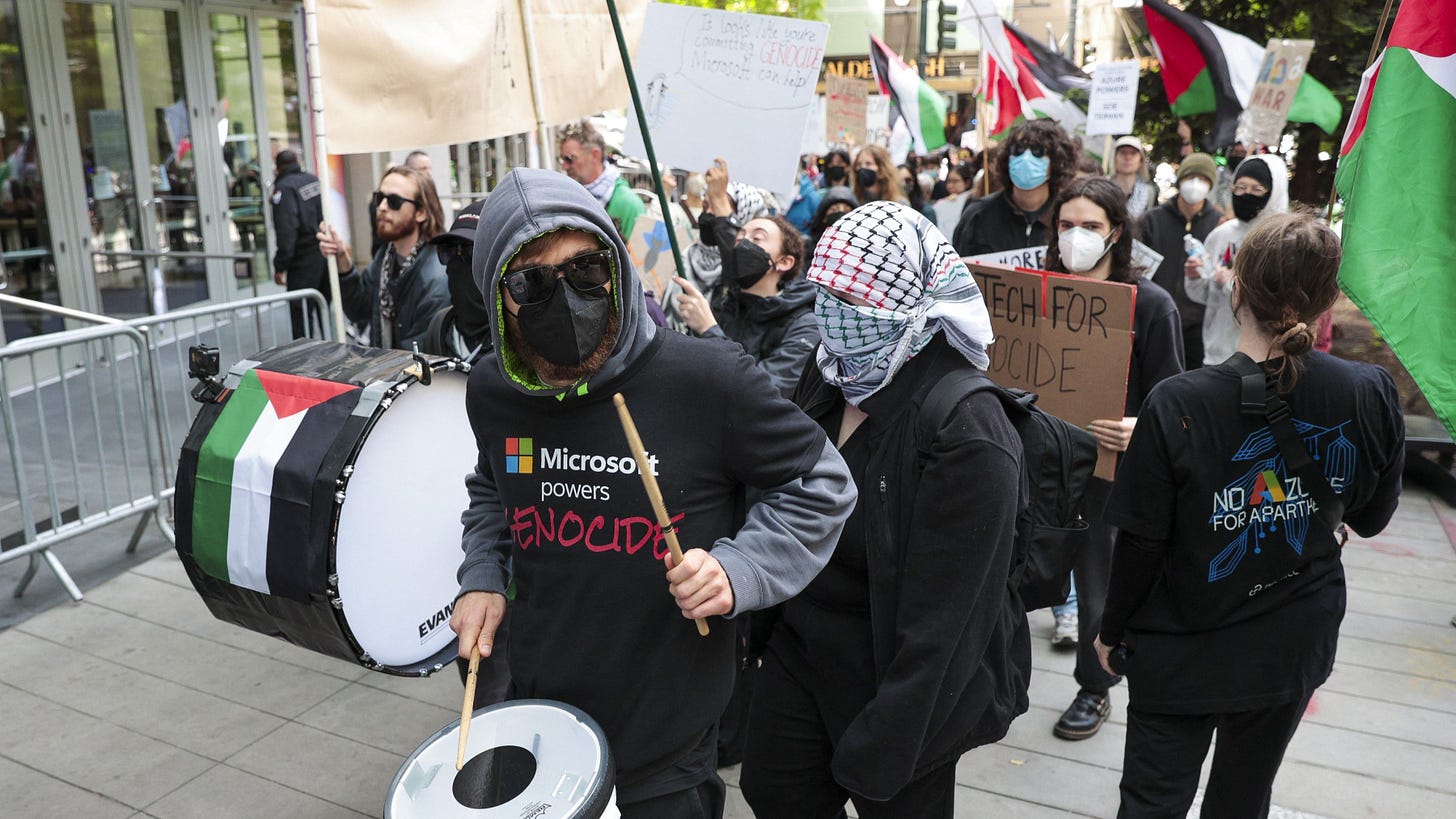 A pro-Palestinian demonstrator plays a drum as they protest outside the Microsoft Build conference at the Seattle Convention Center in Seattle, Washington on May 19, 2025.