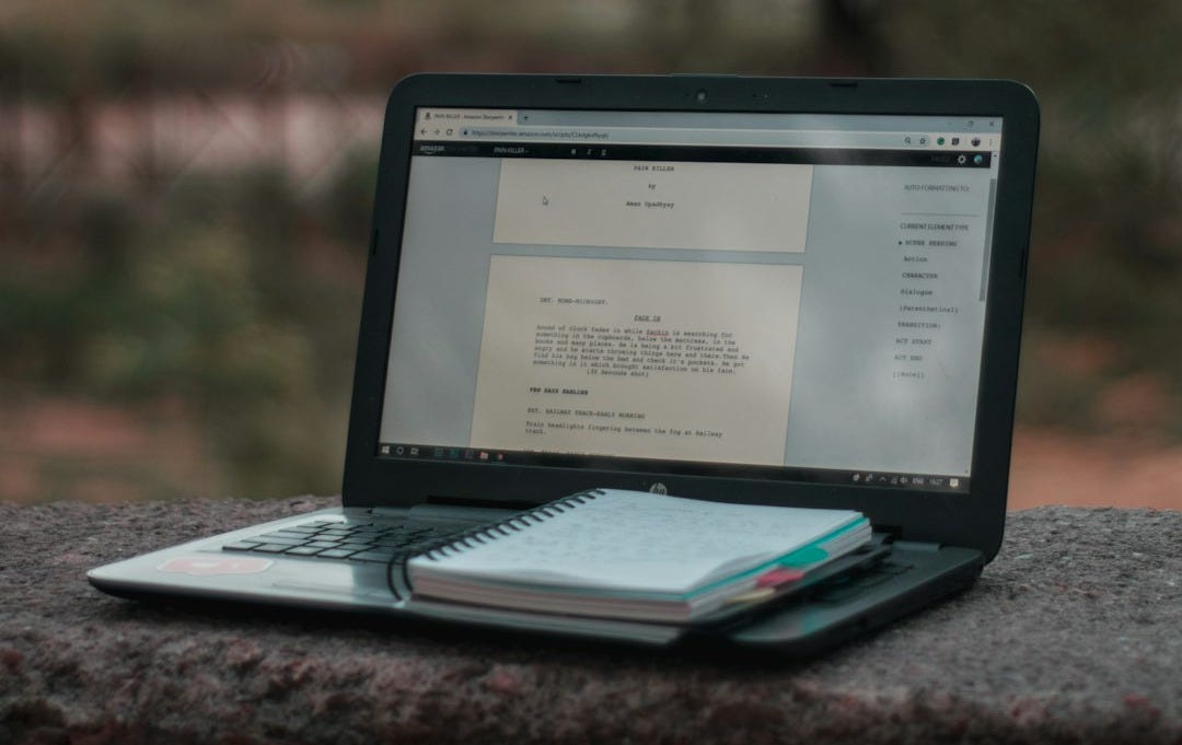 black laptop computer on brown wooden table