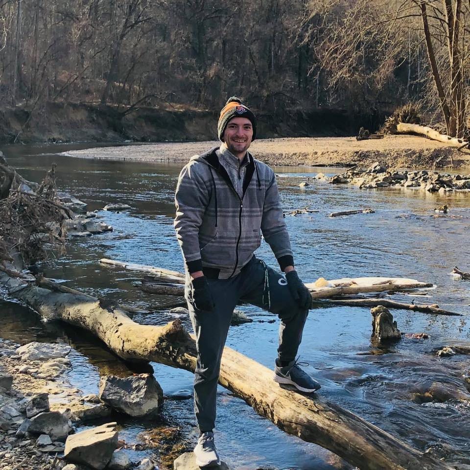 May be an image of 1 person, tree, nature and body of water