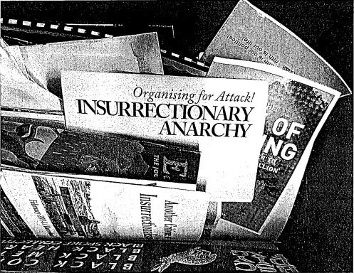 grainy image from PDF showing a box of documents, some of which appear to be only photocopied front pages of revolutionary propaganda grainy image from PDF showing a box of documents, some of which appear to be only photocopied front pages of revolutionary propaganda