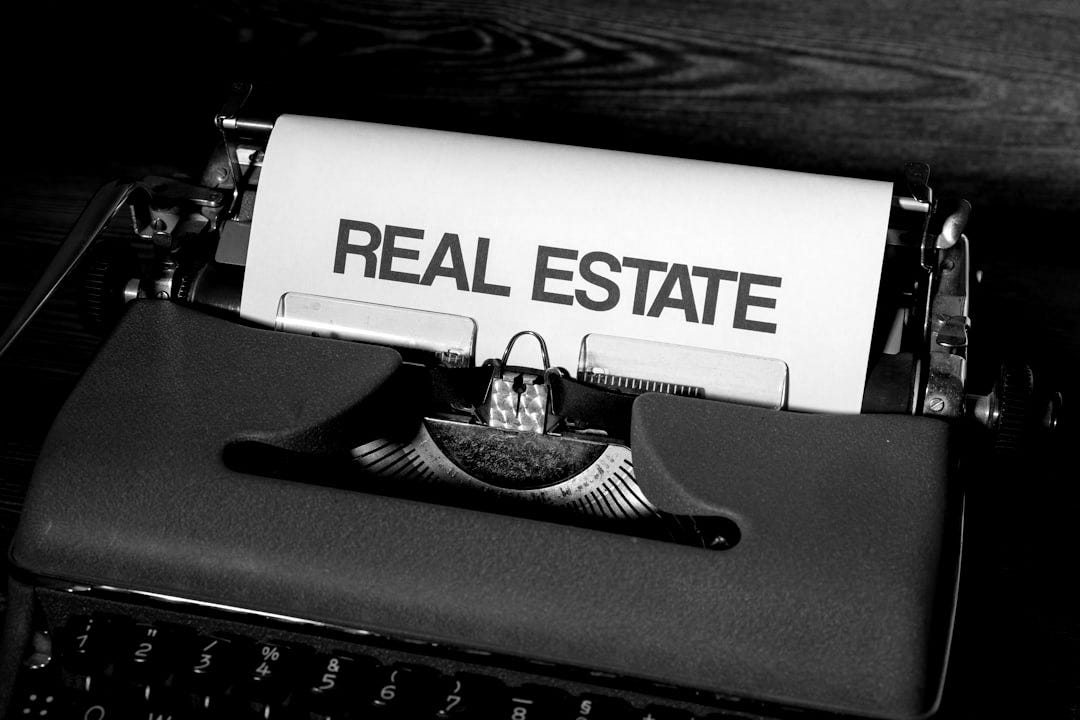 a close up of a typewriter with a real estate paper on it