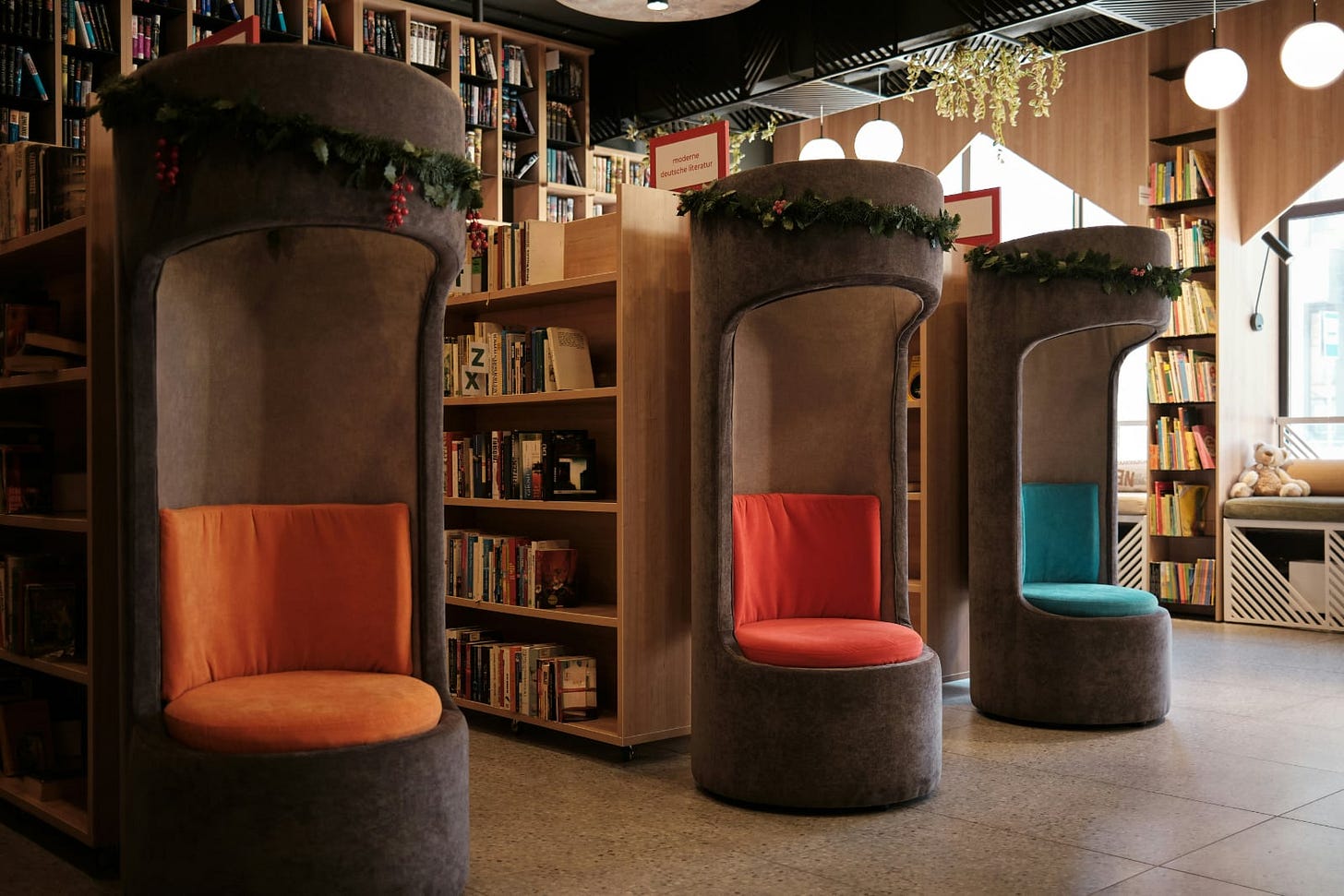 bookshelves in a library with wooden reading kiosks placed at the end of each shelf