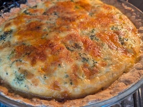 Finished slice of broccoli cheese quiche with tarragon. Pressing in the crust to be ready when the oven is pre-heated. Pie ready to come out of the oven.