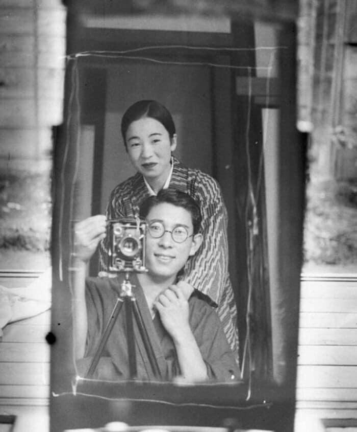 A young Japanese couple captures a mirror selfie in the 1920s. A young Japanese couple captures a mirror selfie in the 1920s.