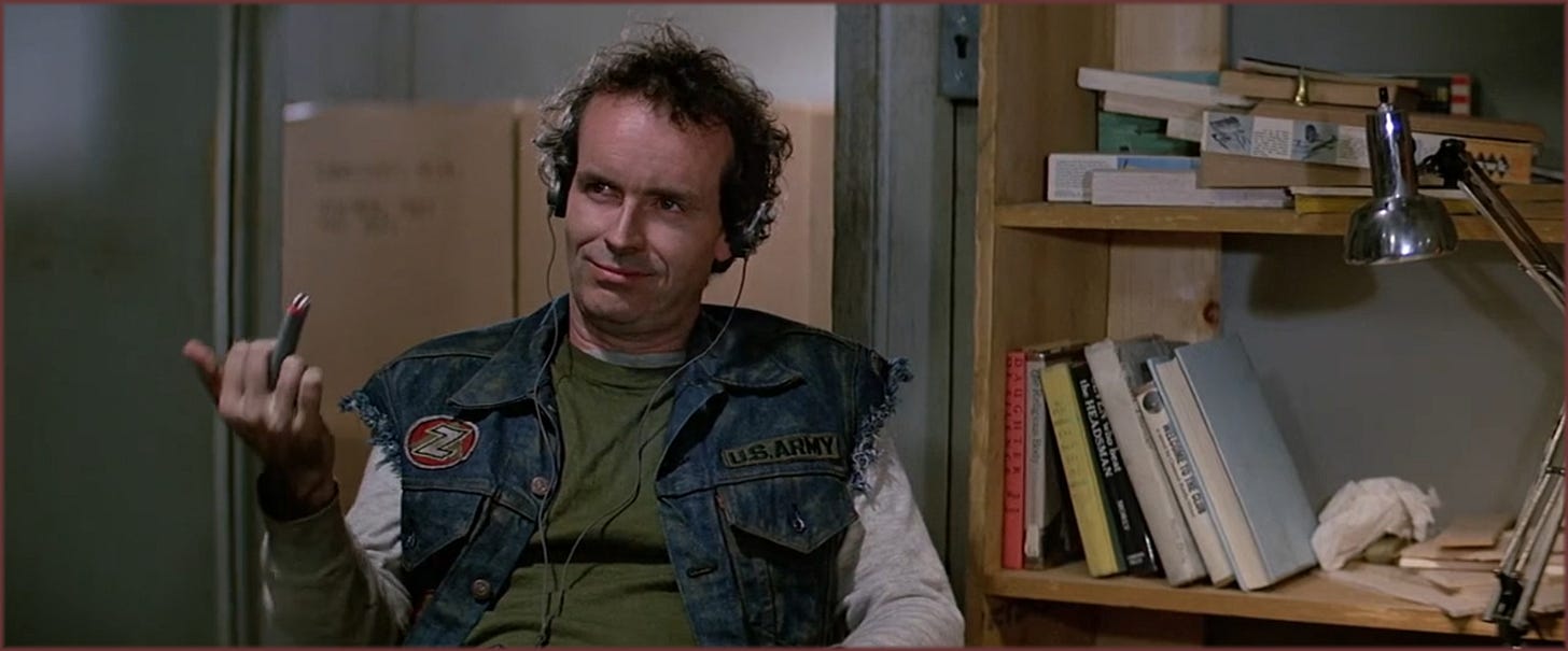 Film frame from The Thing (1982): Palmer (David Clennon) early in the film, relaxed expression, headphones on, before any threat has been established.
