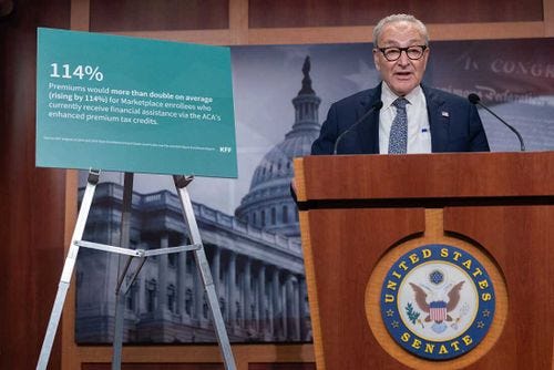 Senate Minority Leader Chuck Schumer, D-N.Y., stands next to an easel during a press conference.