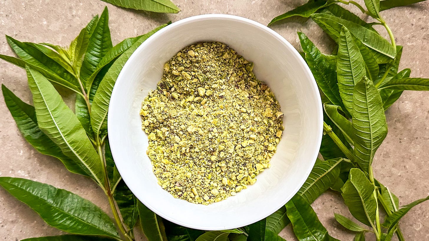 Lemon verbena leaves on the counter and a bowl of coursely ground pistahcios.