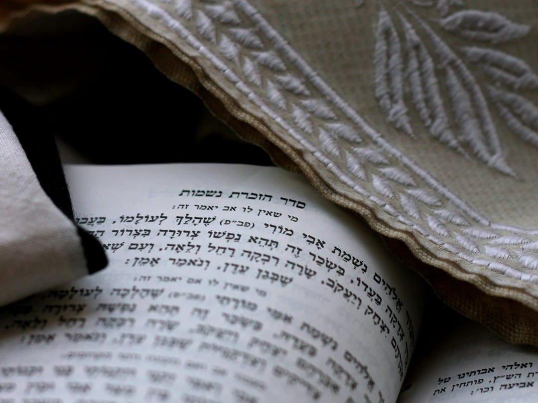 a close up of an open book on a bed a close up of an open book on a bed