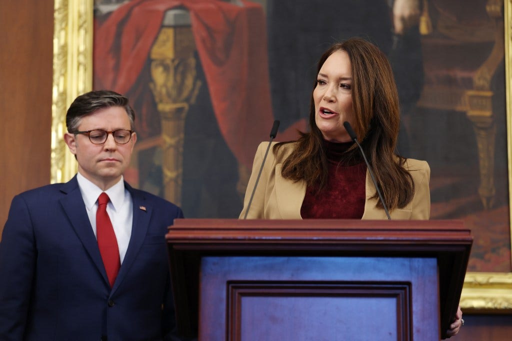 U.S. Agriculture Secretary Brooke Rollins speaks with U.S. Speaker of the House Mike Johnson beside her.