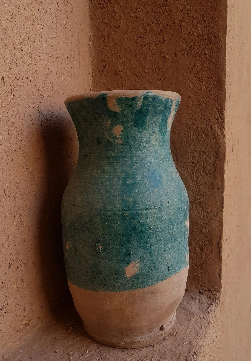 a blue vase on a wall a blue vase on a wall
