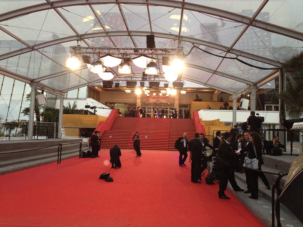 The Cannes red carpet at Theatre de Lumiere, empty but for a few staff and photographers.
