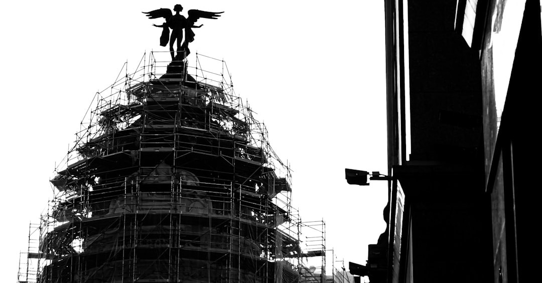 a black and white photo of a building with scaffolding a black and white photo of a building with scaffolding