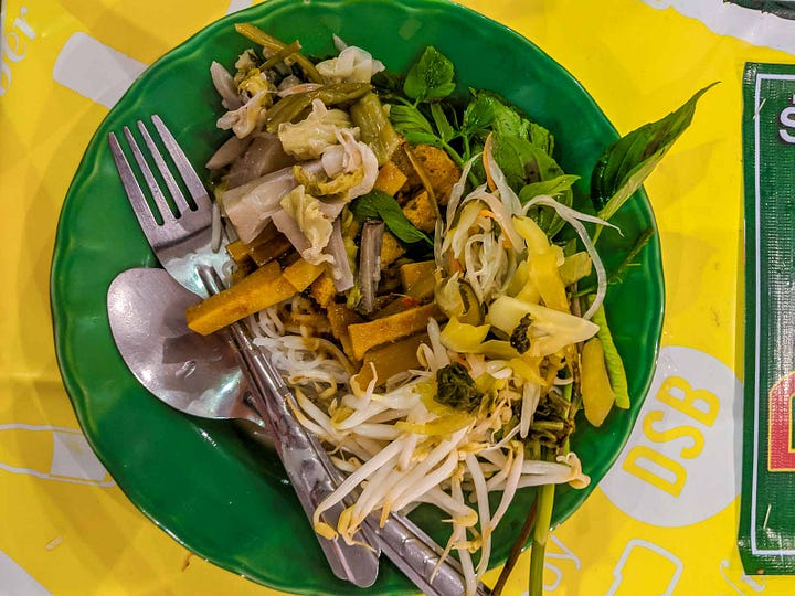 overhead shot of a plate of noodles topped with chunky curry and vegetables