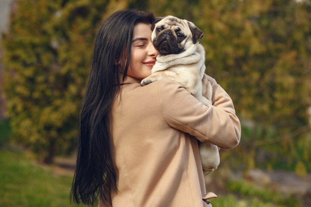 dog mom hugging her pug