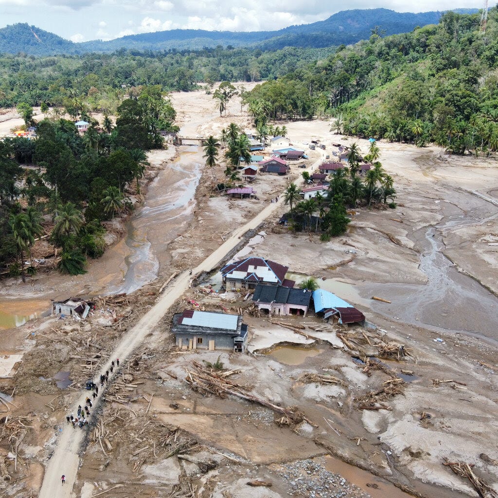Buildings covered by mud and floodwaters.