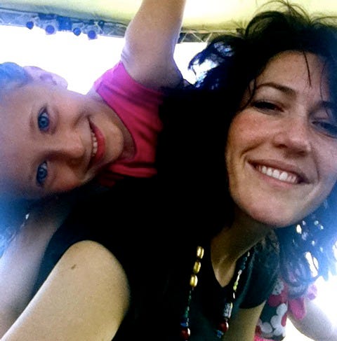 My mom and I smiling with me on her back