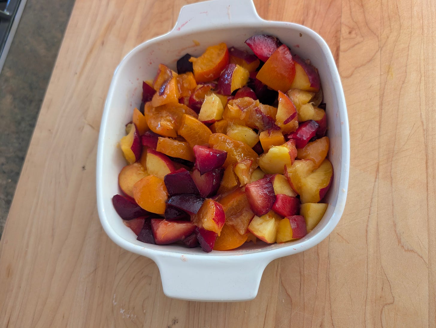 bowl with chopped peaches, plums and apricots