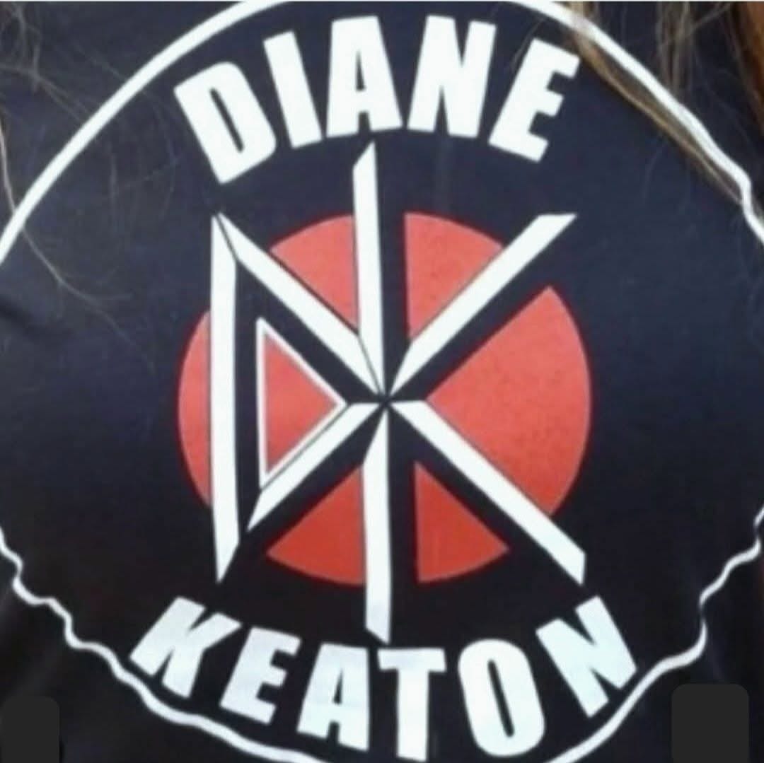 A black and white Dead Kennedys t-shirt with the DK logo and the name Dead Kennedys across the top and bottom replaced by "Diane Keaton."