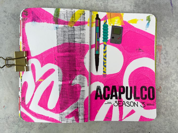 Various art journal pages in a small notebook