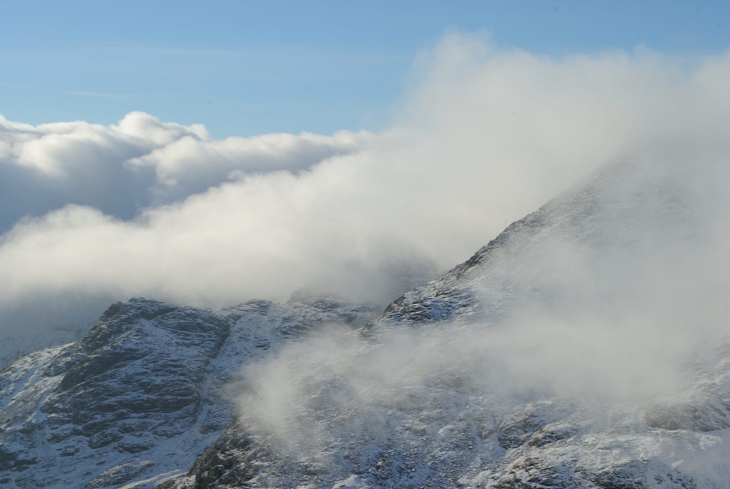 bits of hillside seen through clouds