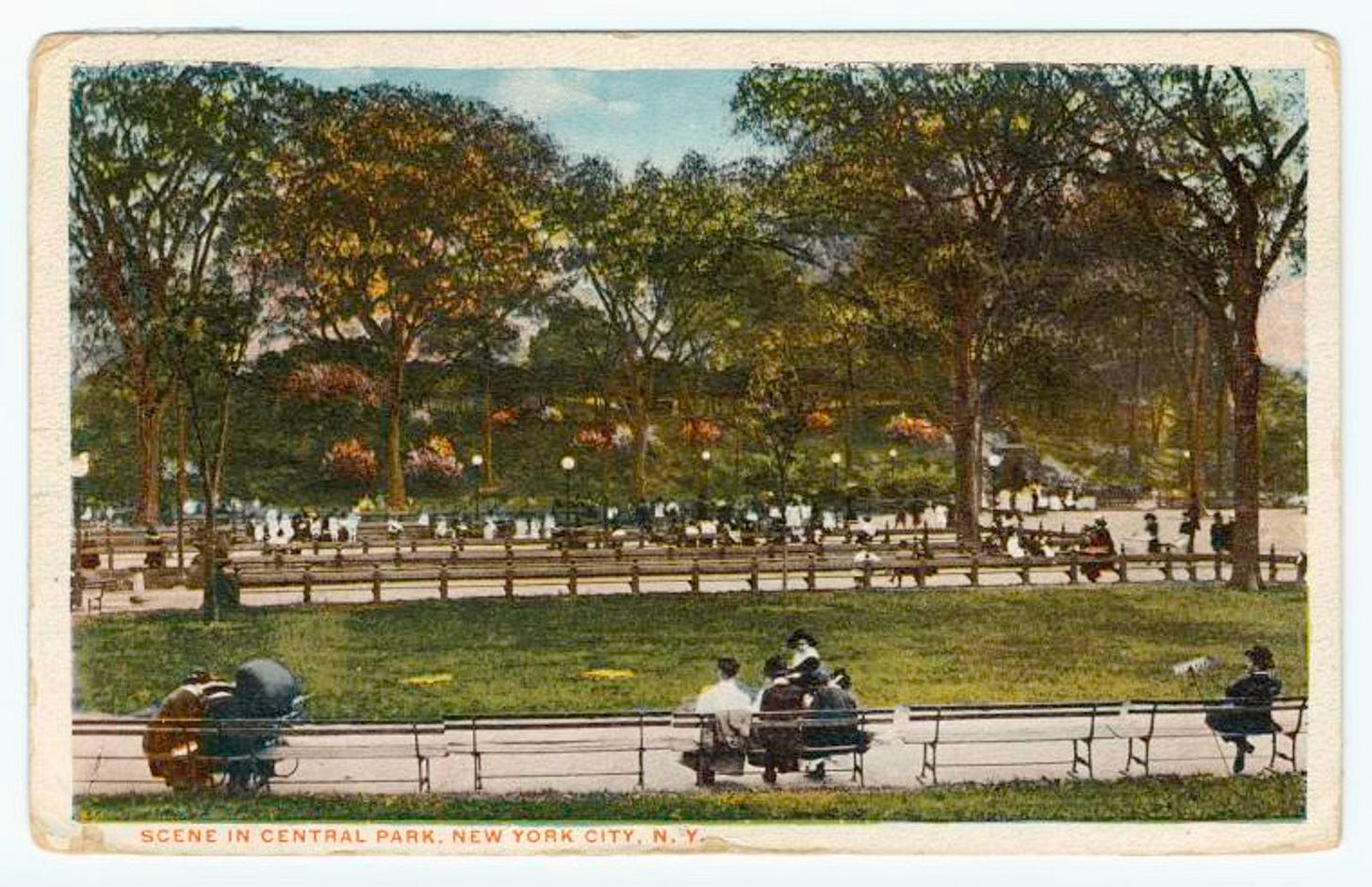 A scan of an old-timey postcard with artificial color. Small figures in old fashioned clothing sit around a large leafy park. Text: SCENE IN CENTRAL PARK, NEW YORK CITY, N.Y.