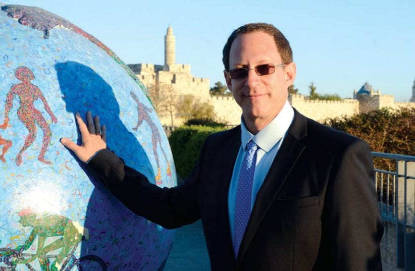 Yosef Abramowitz poses with one of the Green Globes which were scattered around the capital last year. (photo credit: COURTESY ENERGIYA GLOBAL)