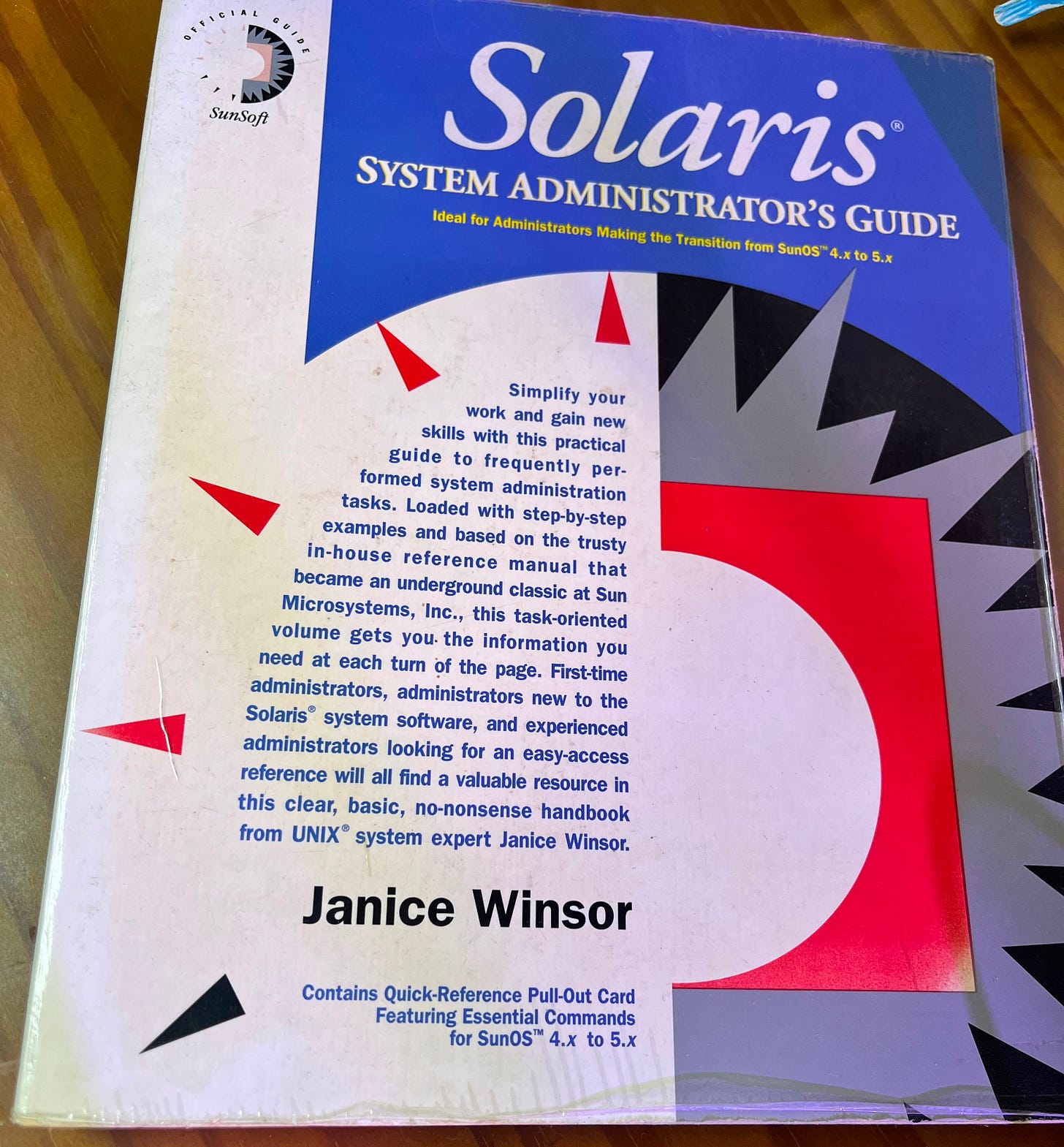 Worn copy of the book "Solaris System Administrator's Guide" by Janice Winsor, SunSoft Official Guide edition, with a large red number 5 on the cover, resting on a wooden table. Worn copy of the book "Solaris System Administrator's Guide" by Janice Winsor, SunSoft Official Guide edition, with a large red number 5 on the cover, resting on a wooden table.