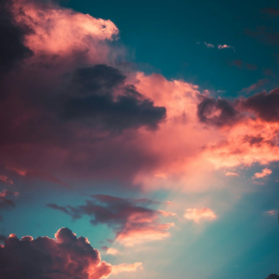 low-angle photography orange and black clouds at golden hour