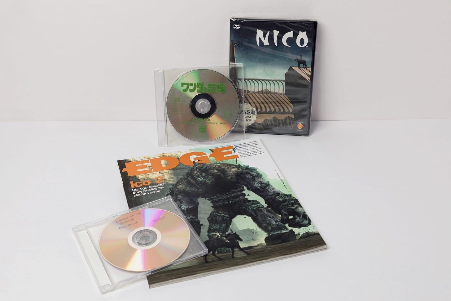A photo shows three discs arranged around an old copy of Edge magazine.