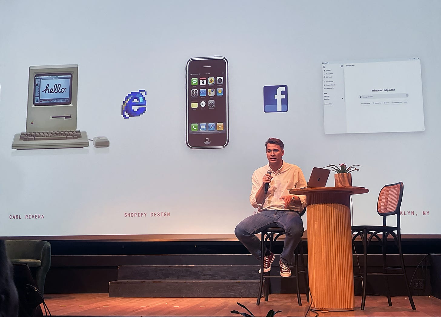 Carl Rivera, Chief Design Officer at Shopify, speaking at Kinference 2025. The slide behind him shows 5 images: the first Macintosh computer, an Internet Explorer icon, the first iPhone, a Facebook icon, and a ChatGPT window