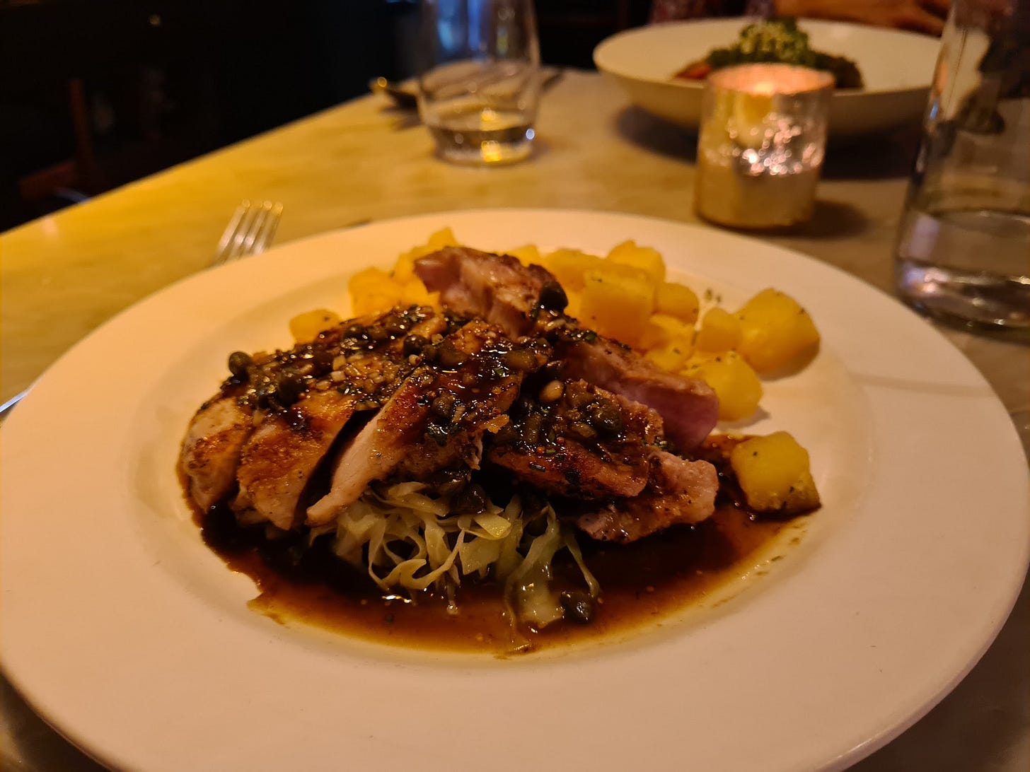 Wood-fired Duroc pork chop with sauce Robert, garlic butter fried potatoes.