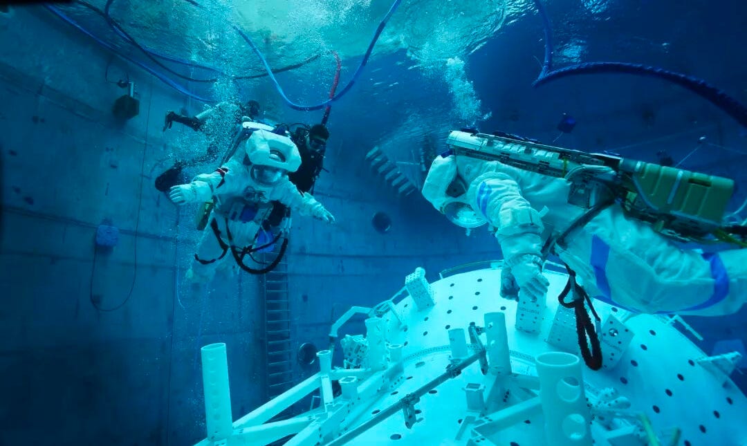 Zhang Lu (red suit) and Wu Fei (blue suit) conduct a spacewalk practice exercise in a neutral buoyancy pool a few months before their launch to Tiangong. Zhang Lu (red suit) and Wu Fei (blue suit) conduct a spacewalk practice exercise in a neutral buoyancy pool a few months before their launch to Tiangong.