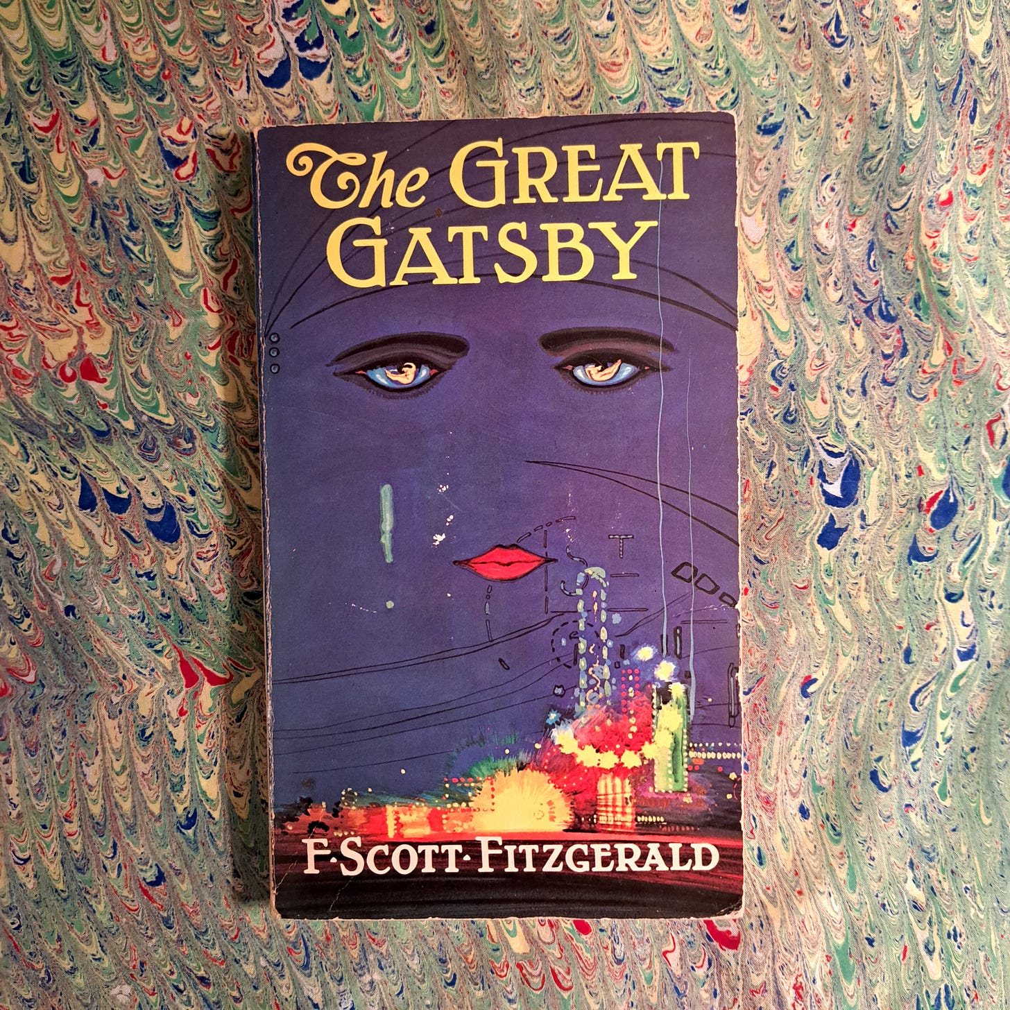The Great Gatsby book cover on a silk scarf with pale green, red and blue marbling