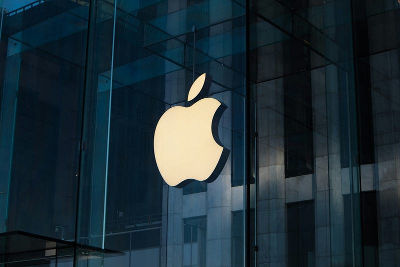 a picture of the Apple office with its logo on a dark building a picture of the Apple office with its logo on a dark building