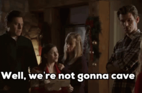 a group of people standing next to each other with the words " well we 're not gonna cave "