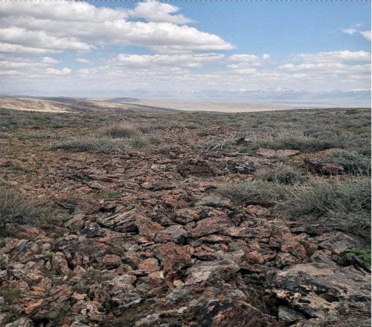 Photo 12a: Rocky scree on hillsides in distance, puzzled rock flows in foreground