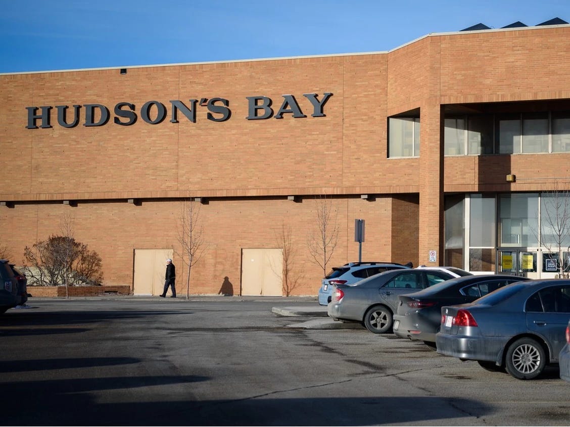 The Hudson's Bay store at Sunridge Mall, Calgary, on Wednesday, 18 January, 2023. A large brick building, largely windowless but with two delivery entrances, and the name Hudson's Bay above. In the foreground are parked cars. Azin Ghaffari/Postmedia file. 