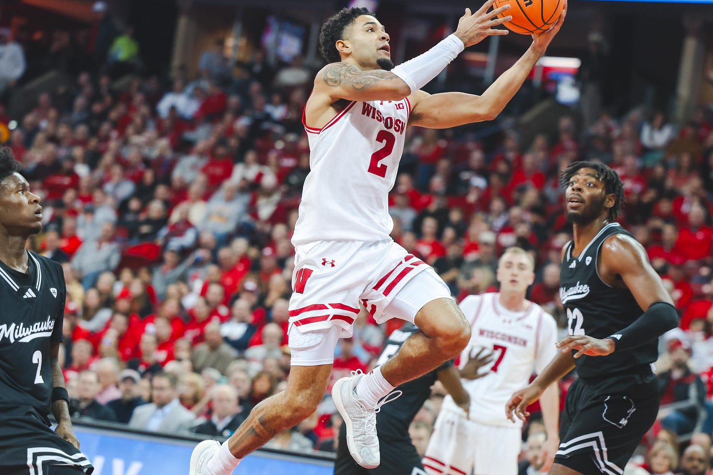 Wisconsin Badgers point guard Nick Boyd leaves both of his feet to jump toward the hoop with the basketball
