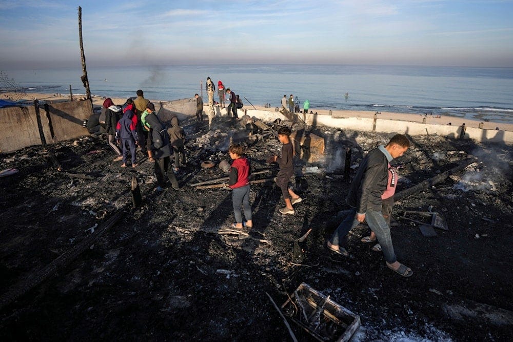 Palestinians inspect the site of an Israeli occupation forces strike early Tuesday morning in Deir al-Balah in the central Gaza Strip, Tuesday, January 14, 2025 (AP) Palestinians inspect the site of an Israeli occupation forces strike early Tuesday morning in Deir al-Balah in the central Gaza Strip, Tuesday, January 14, 2025 (AP)