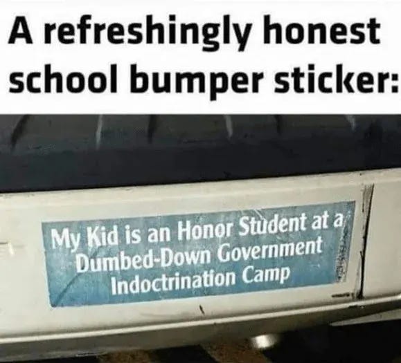 A bumper sticker on a vehicle. The sticker has text reading "My Kid is an Honor Student at a Dumbed-Down Government Indoctrination Camp" in blue and white.