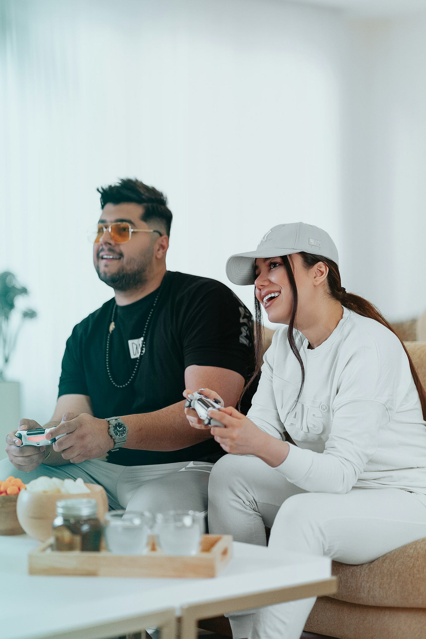 man in black crew neck t-shirt sitting beside woman in white long sleeve shirt man in black crew neck t-shirt sitting beside woman in white long sleeve shirt
