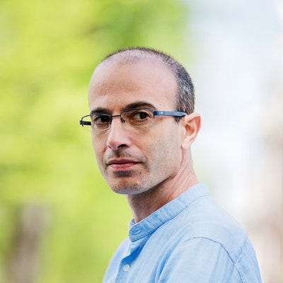 A person wearing glasses and a blue shirt

Description automatically generated