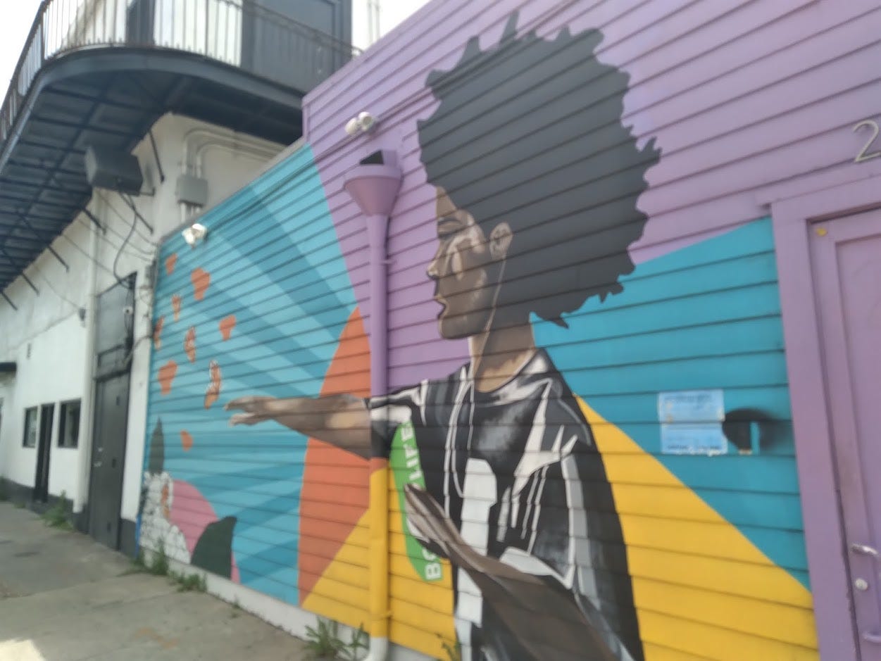 A brightly colored mural of a child reaching for butterflies.