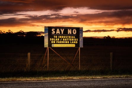 Sign saying ‘say no to industrial solar batteries on farming land’ on a large sign framed against a sunset Sign saying ‘say no to industrial solar batteries on farming land’ on a large sign framed against a sunset