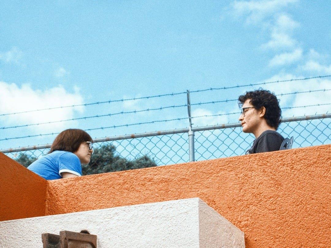 Two people talking on a rooftop Two people talking on a rooftop