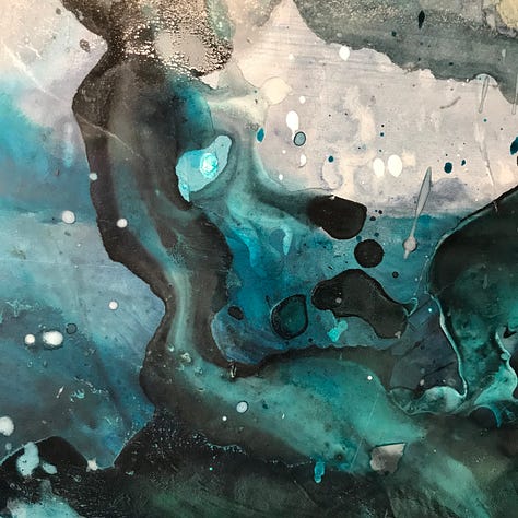 Some paintings as works in progress, with swirls of blue, green and silver.