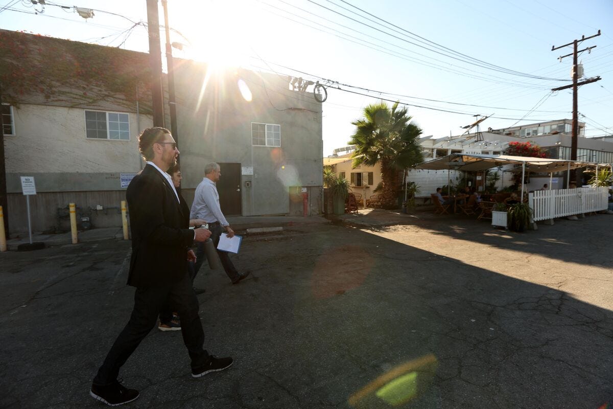 Scott Walter and another man walk across a Santa Monica lot. Scott Walter and another man walk across a Santa Monica lot.