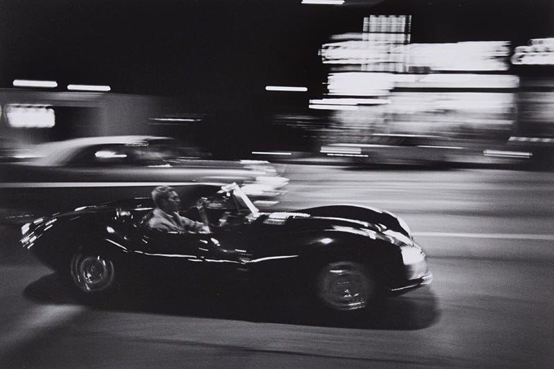 photo of Steve McQueen driving at night in LA. Photo by John Dominis