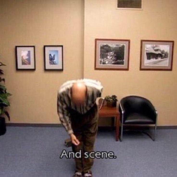 This may contain: a man standing in an office looking at the ground