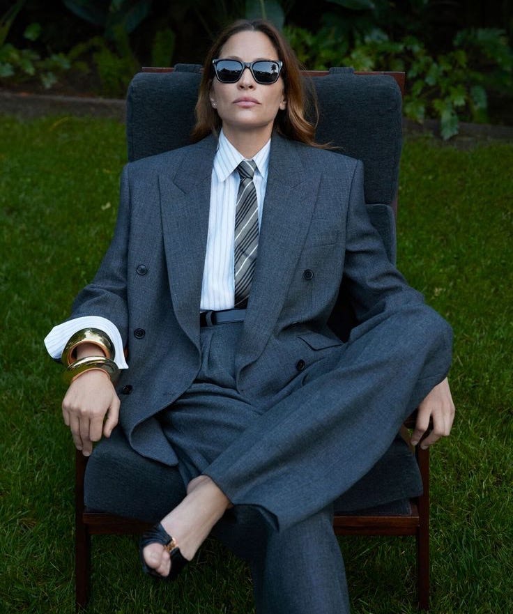 This may contain: a man in a suit and tie sitting on a lawn chair with his legs crossed This may contain: a man in a suit and tie sitting on a lawn chair with his legs crossed